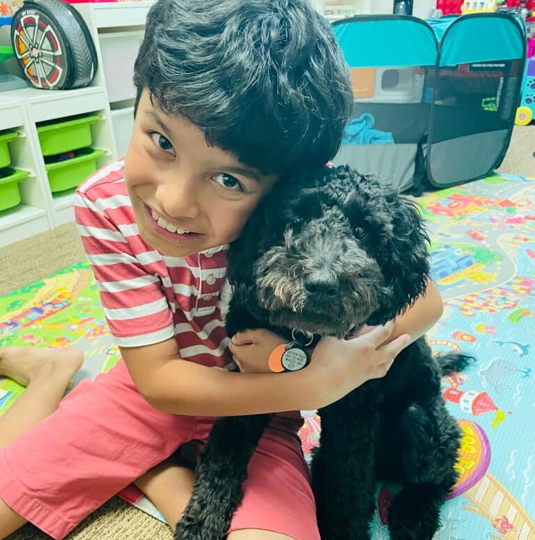 boy hugging a small dog